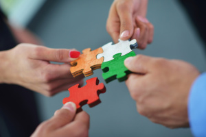 Group of business people assembling jigsaw puzzle